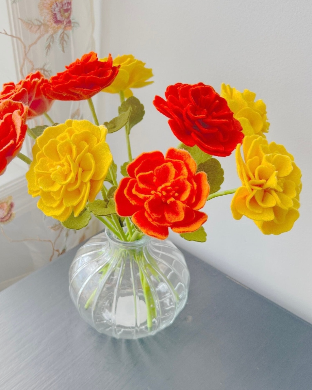 a glass vase filled with colorful flowers on top of a table