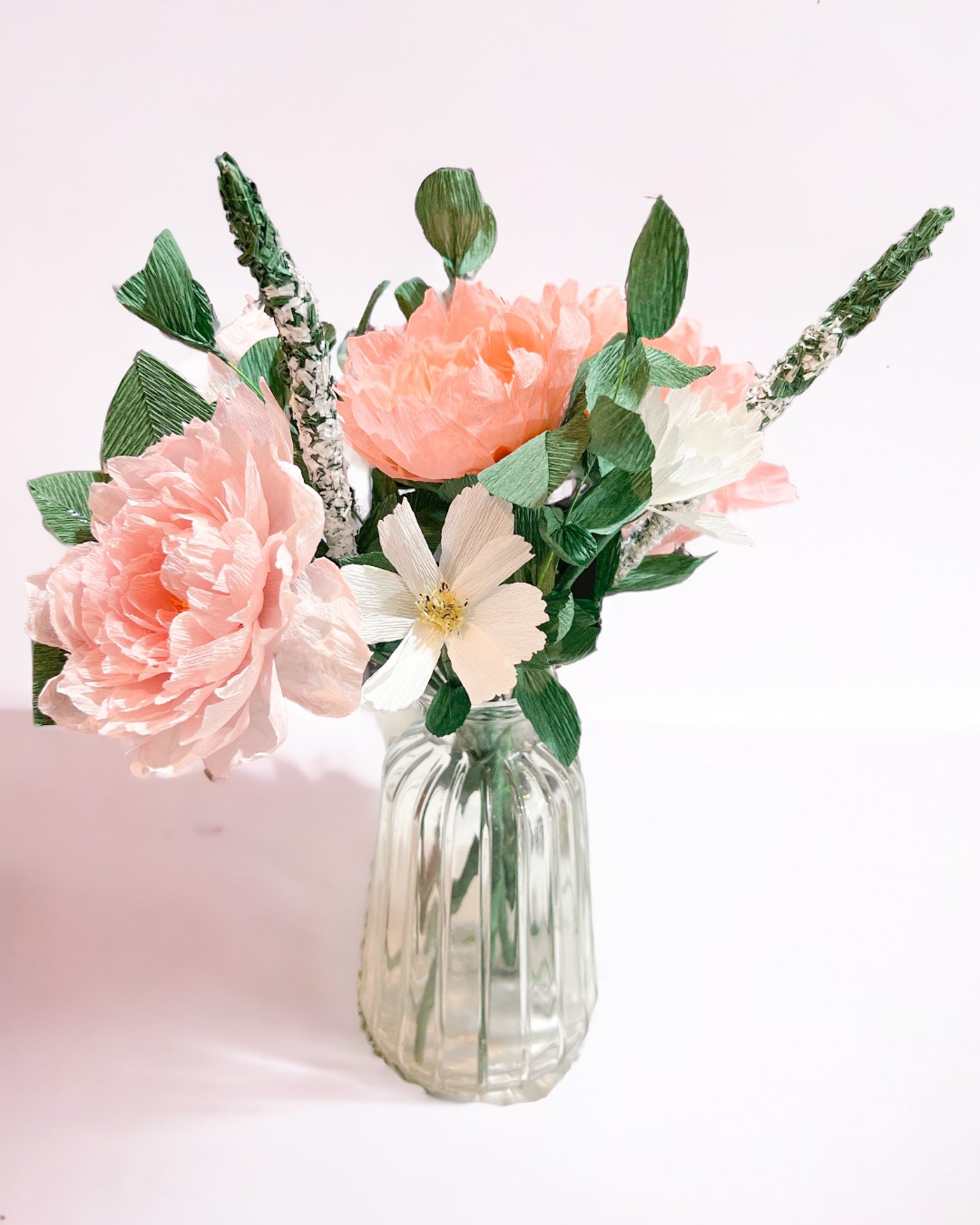 a vase filled with pink and white flowers
