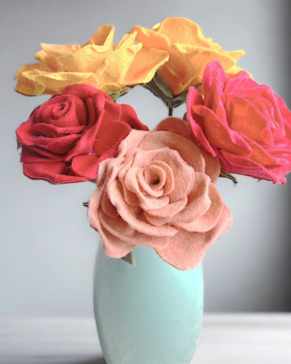 a vase filled with flowers sitting on top of a table
