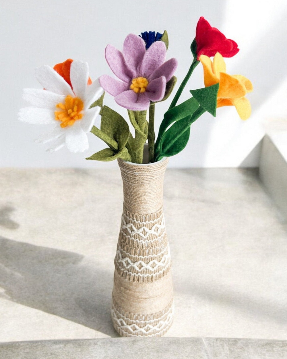 a vase filled with colorful flowers on top of a table