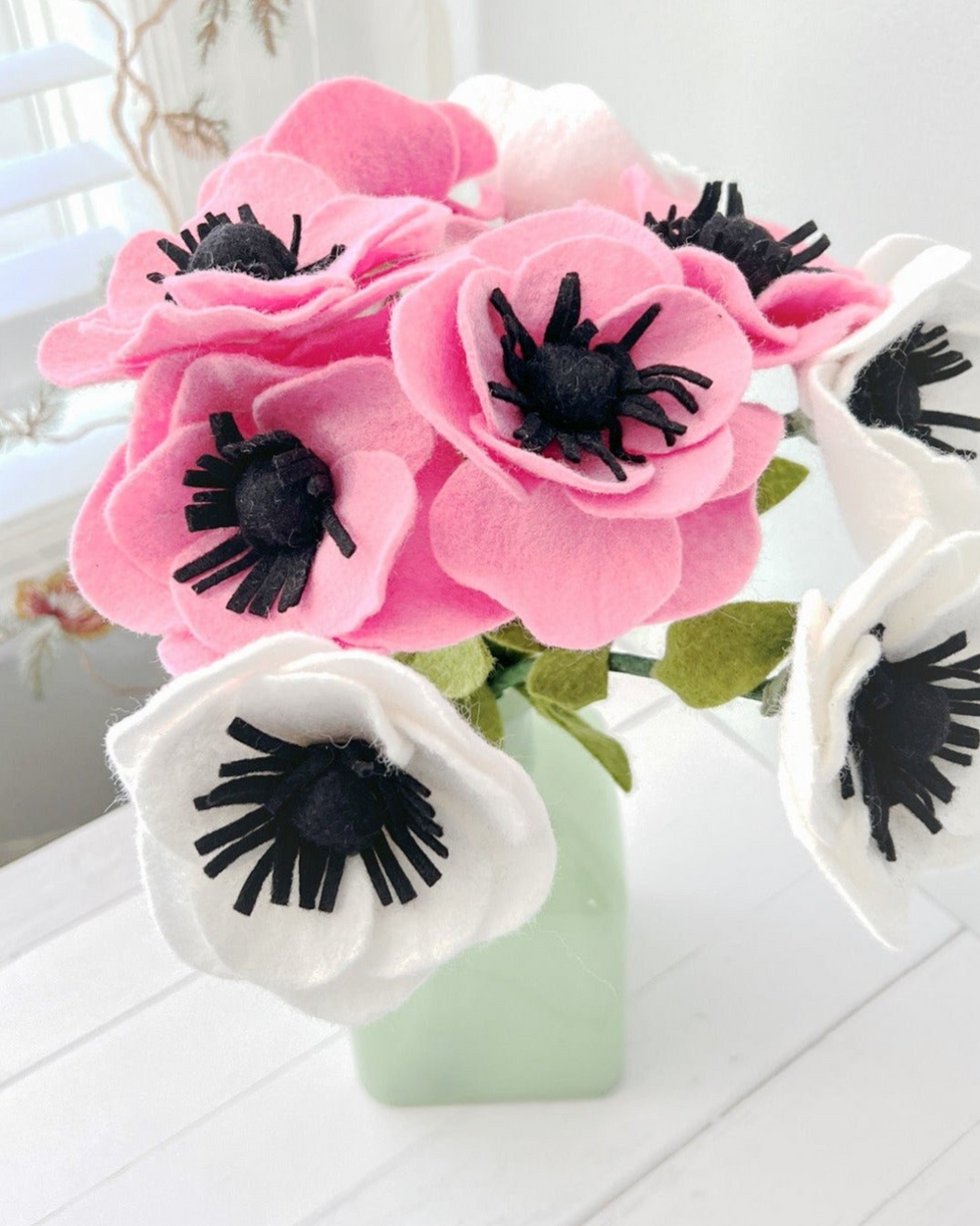 a vase filled with pink and white flowers