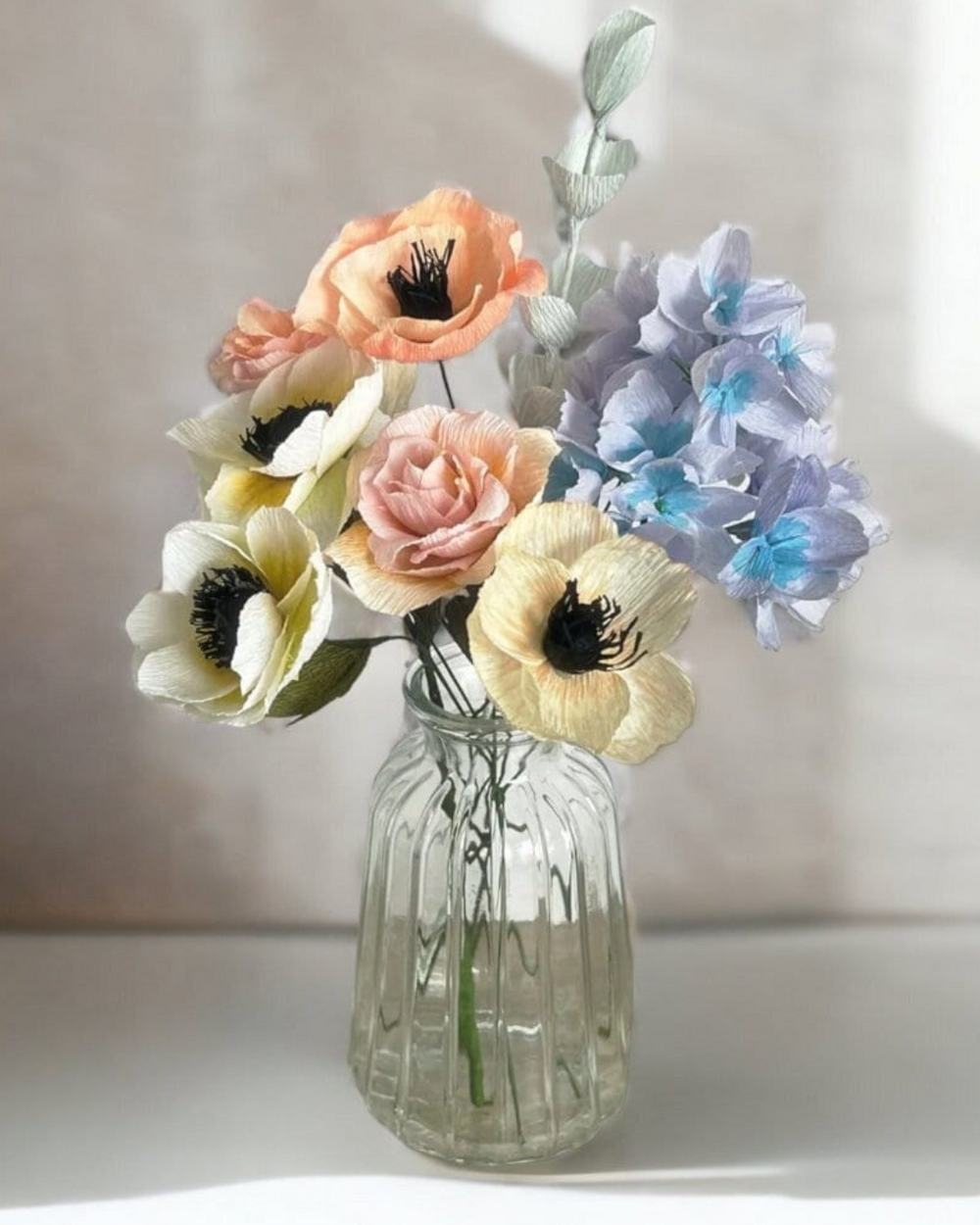 a vase filled with colorful flowers on top of a table