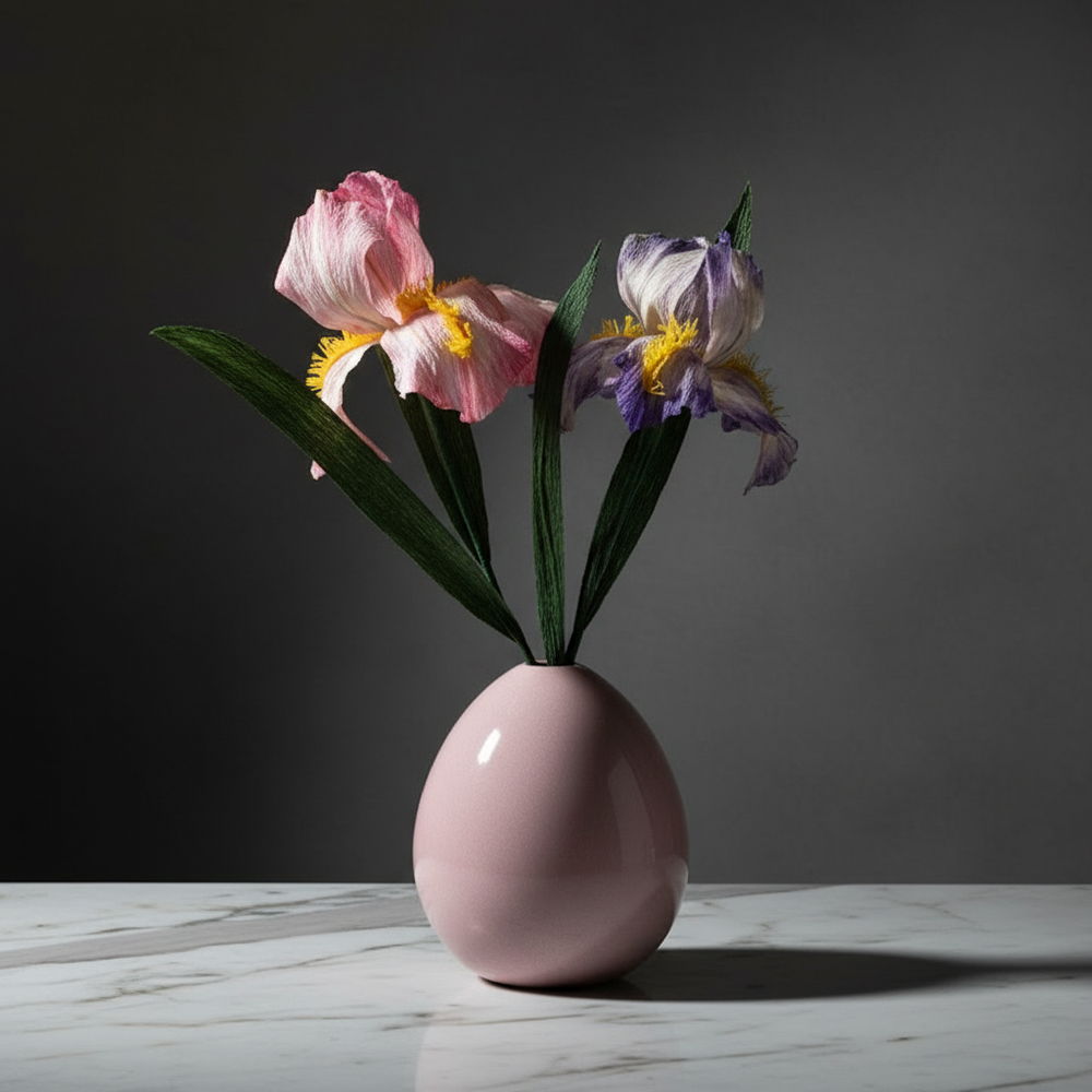 a pink vase filled with flowers on top of a white table