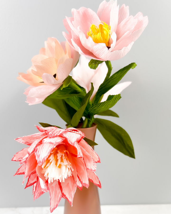 a vase filled with pink and white flowers