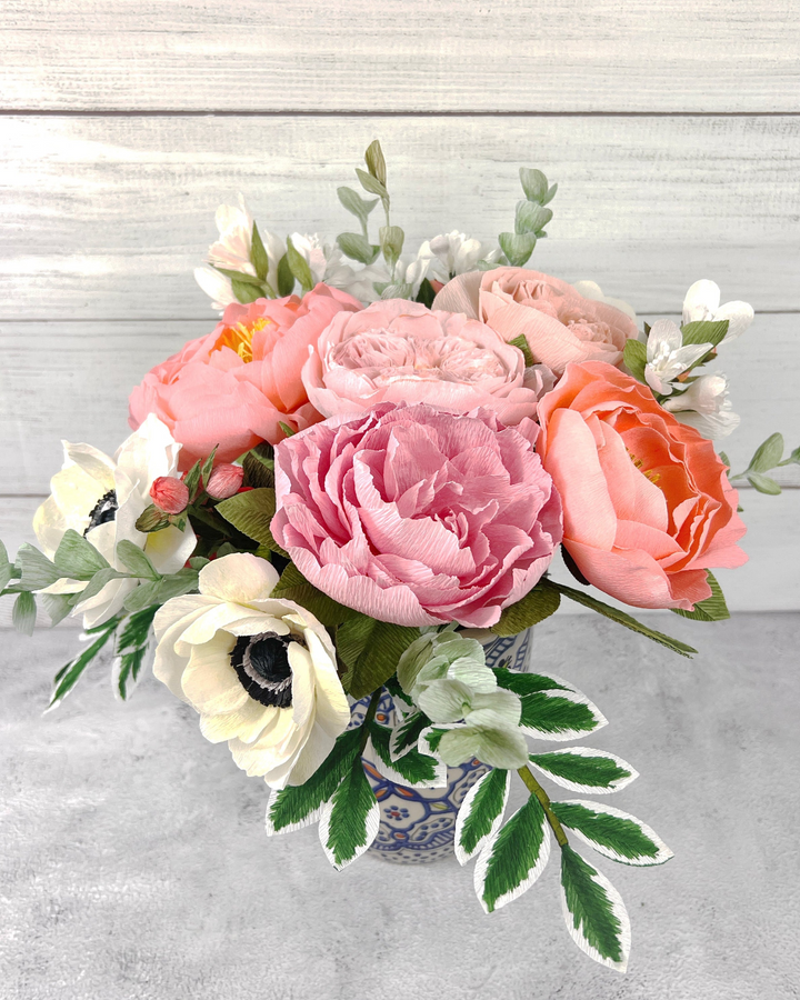 a bouquet of flowers in a vase on a table