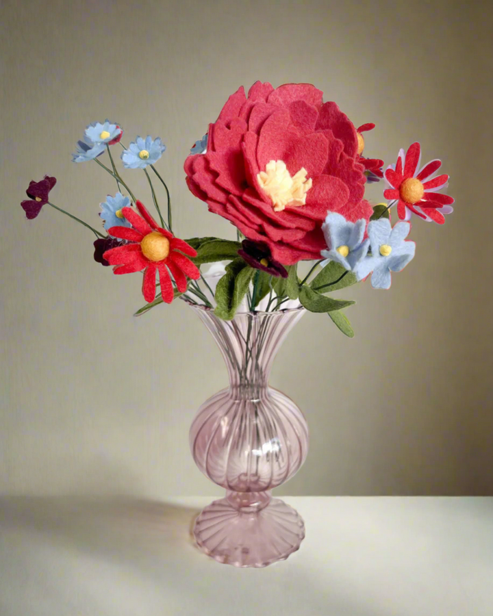 a glass vase filled with flowers on top of a table