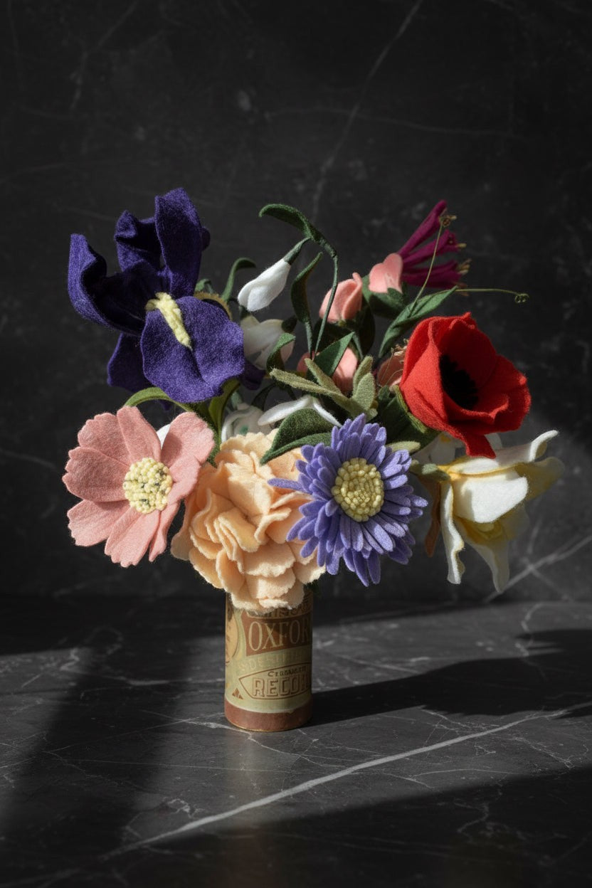 Melly Meier Botanicals felt flower bouquet with purple iris, peach carnations, pink cosmos, red poppy, and white daffodils.