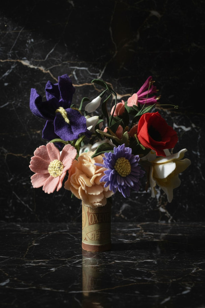 Melly Meier Botanicals bouquet of felt flowers including purple iris, pink daisy, peach carnation, and red poppy.