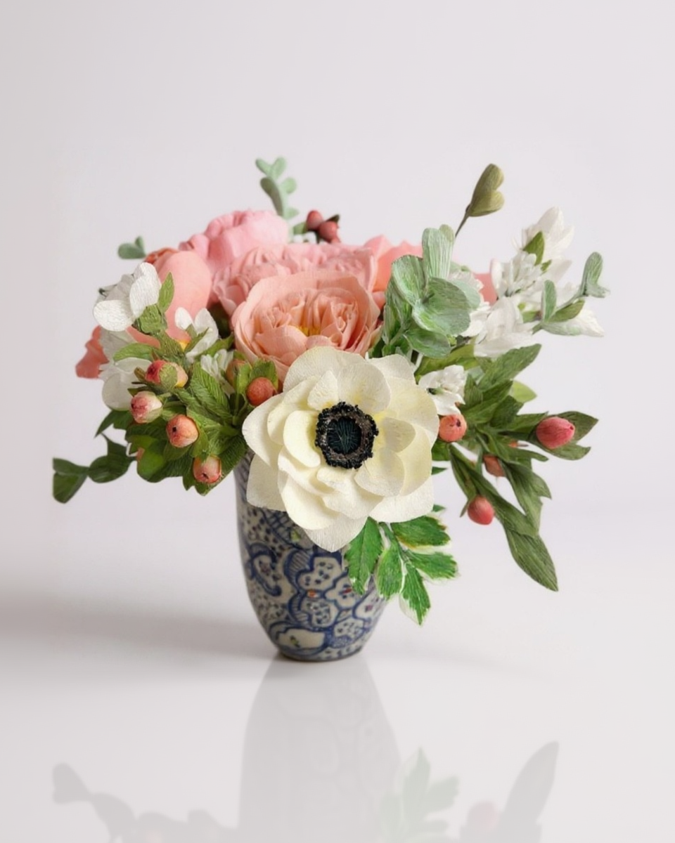 Floral arrangement in a decorative vase on a light background